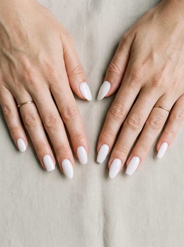 Round, squoval, almond, and coffin nail shapes painted in the same milky white shade